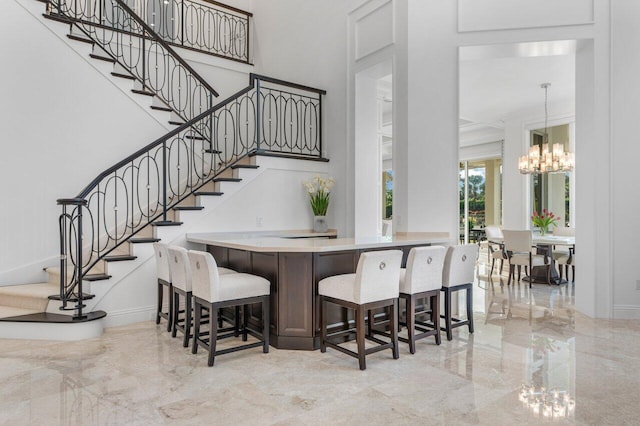 dining space with a towering ceiling and an inviting chandelier