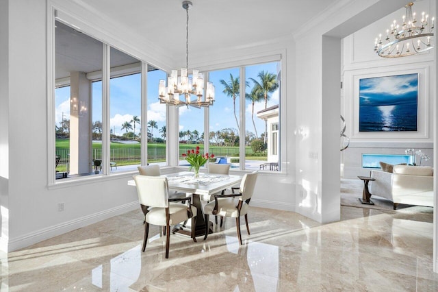 dining space with ornamental molding, plenty of natural light, and a chandelier