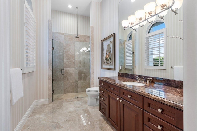 bathroom with vanity, a shower with shower door, a chandelier, and toilet