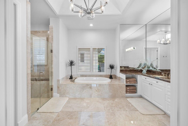 bathroom with vanity, a chandelier, and separate shower and tub