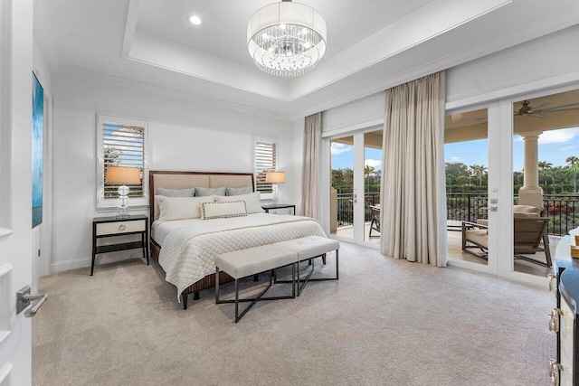 bedroom with access to outside, ornamental molding, a raised ceiling, a notable chandelier, and light colored carpet