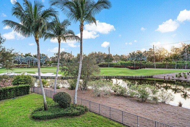 surrounding community featuring a water view and a lawn