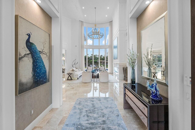 foyer featuring a high ceiling and an inviting chandelier