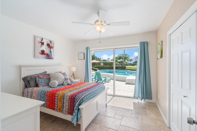 bedroom with ceiling fan, access to outside, stone tile flooring, and baseboards