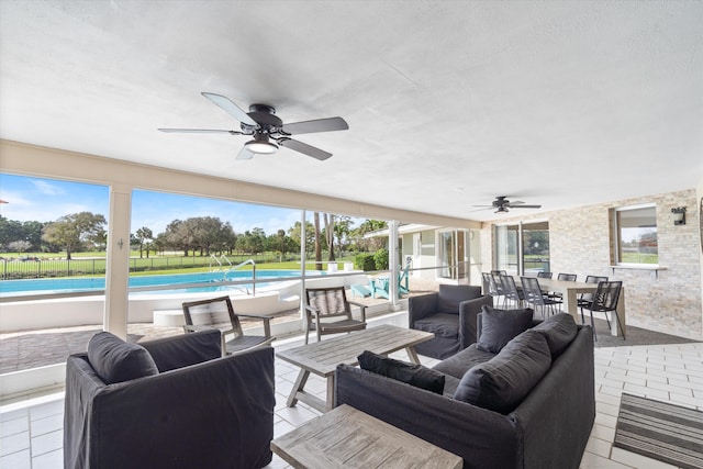 view of patio with outdoor dining area, fence, a ceiling fan, an outdoor living space, and an outdoor pool