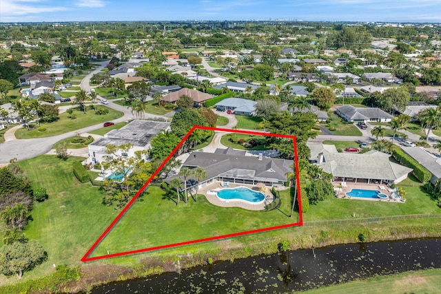 birds eye view of property with a water view and a residential view