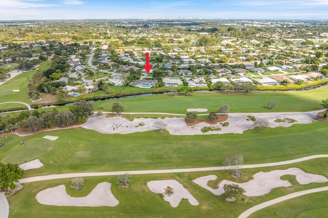 drone / aerial view featuring view of golf course and a residential view