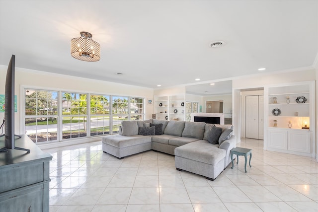 living area featuring light tile patterned floors, visible vents, built in features, and ornamental molding