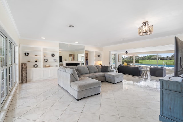 living room featuring light tile patterned floors, visible vents, ornamental molding, and built in features