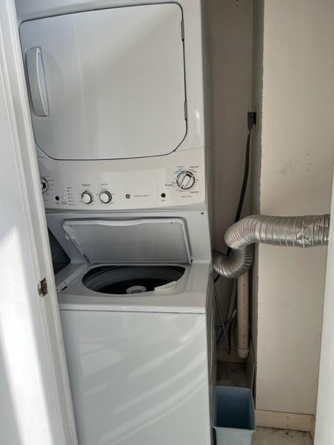 laundry room with stacked washer / dryer