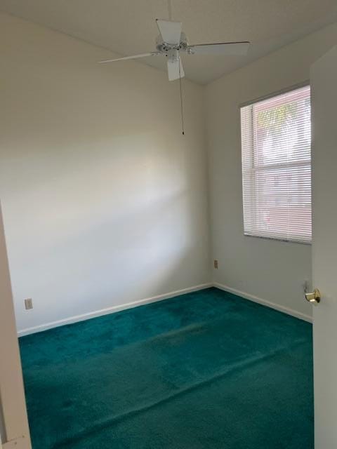 unfurnished room with ceiling fan and carpet flooring