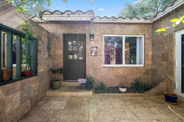 doorway to property with a patio