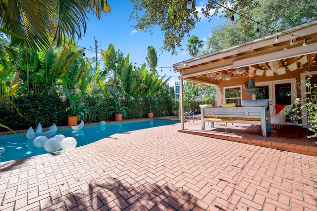 view of pool with ceiling fan and a patio area