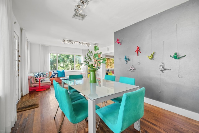 dining space with dark hardwood / wood-style floors