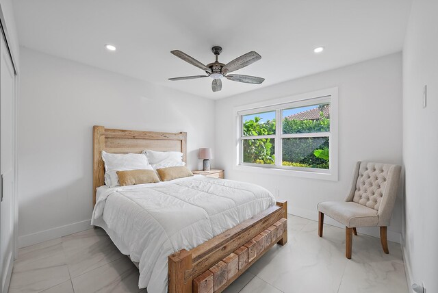 bedroom with recessed lighting, marble finish floor, and baseboards