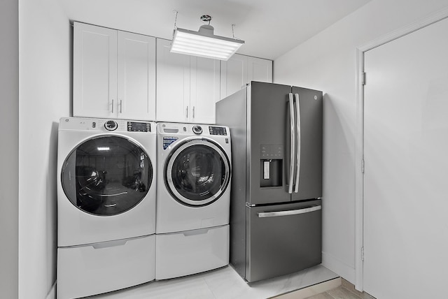 laundry area featuring washer and dryer and cabinet space