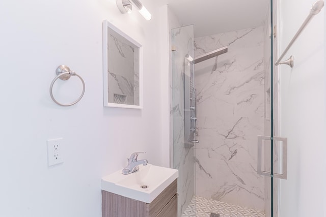 bathroom featuring vanity and a shower with shower door