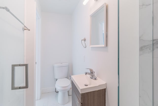 bathroom featuring vanity, an enclosed shower, and toilet