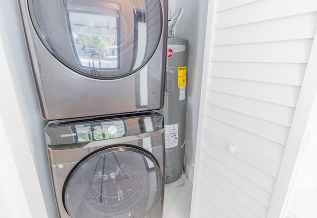 laundry room featuring stacked washing maching and dryer and electric water heater