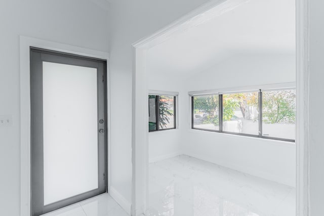 empty room featuring lofted ceiling