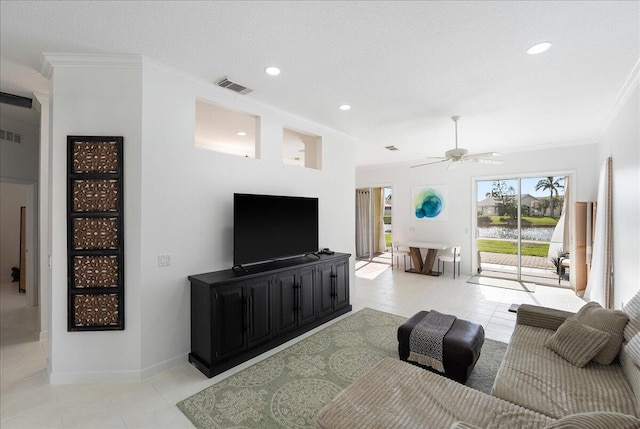 tiled living room with crown molding, ceiling fan, and a textured ceiling