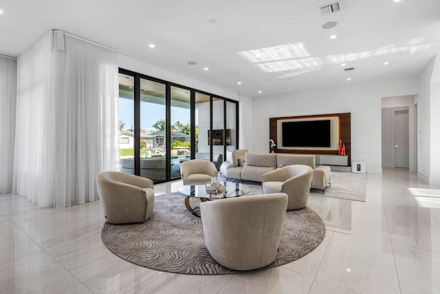 living area with visible vents and recessed lighting