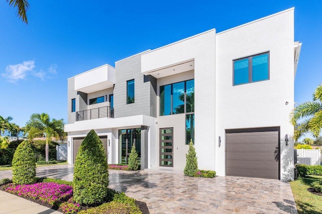 contemporary home featuring a garage and a balcony