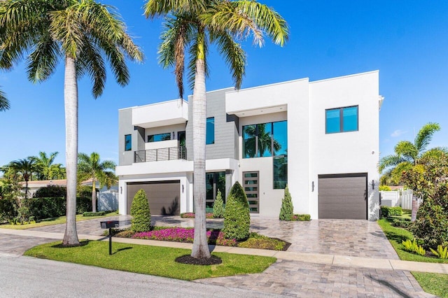 contemporary house with a garage and a balcony