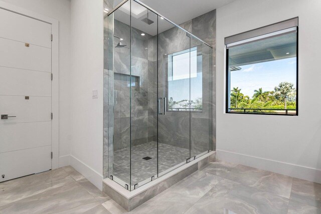 full bathroom featuring a stall shower and marble finish floor