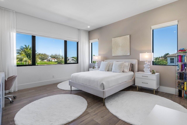 bedroom with recessed lighting, baseboards, and wood finished floors