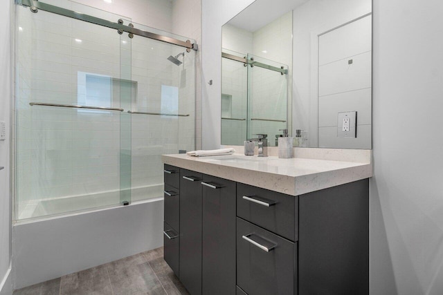 full bath featuring bath / shower combo with glass door, wood finished floors, and vanity