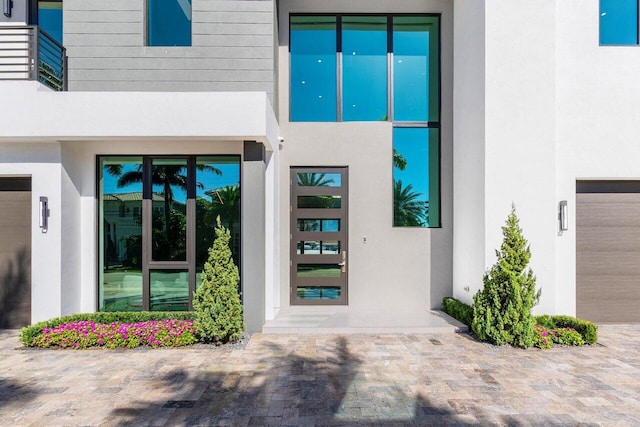 doorway to property featuring stucco siding