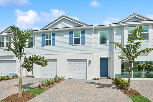 107 SE Birch Ter Unit 1263, Stuart, FL 34997 - view of front facade with a garage and driveway