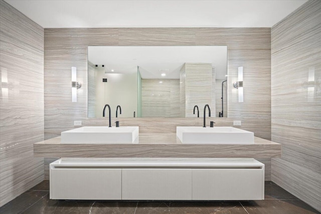 bathroom featuring vanity, tile walls, and walk in shower