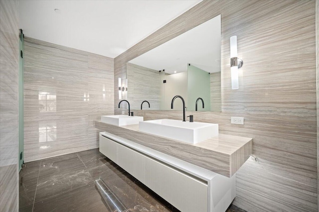 bathroom with tile walls and vanity