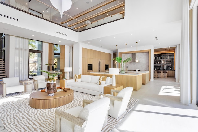 living area featuring a high ceiling and recessed lighting