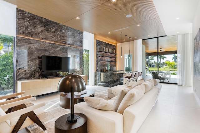 living area featuring expansive windows, indoor wet bar, recessed lighting, and light tile patterned floors