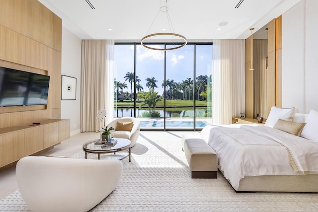 bedroom featuring expansive windows, access to outside, and a water view