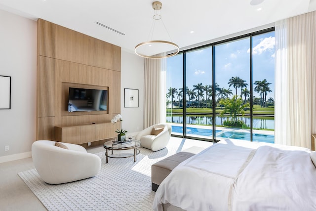 bedroom featuring access to exterior, visible vents, floor to ceiling windows, and baseboards