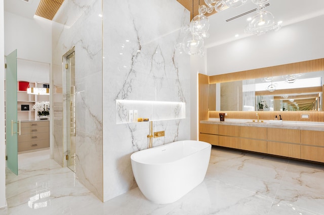 full bath with marble finish floor, double vanity, a marble finish shower, and stone wall