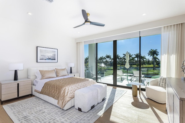 bedroom featuring access to outside, light wood-style flooring, and a ceiling fan