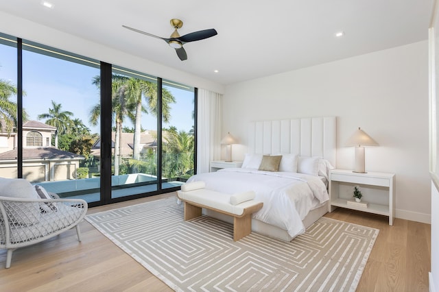 bedroom with access to exterior, light wood-type flooring, baseboards, and a ceiling fan