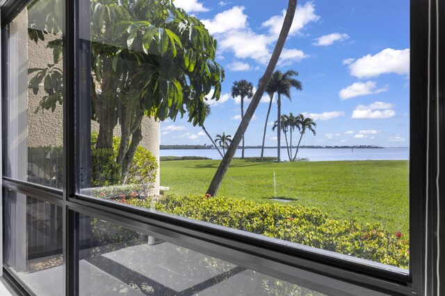 unfurnished sunroom with a water view