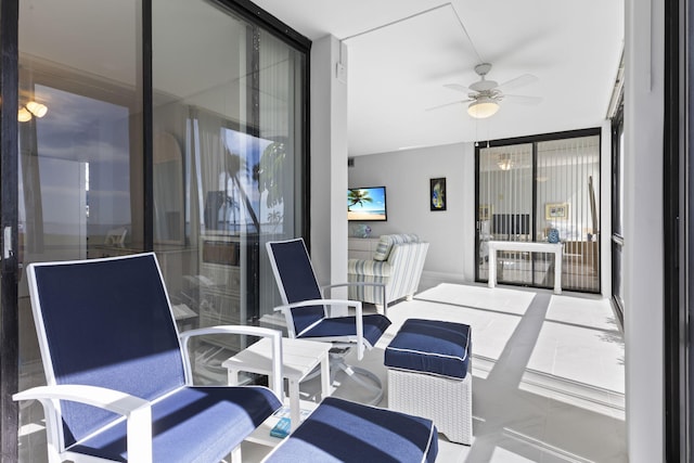 sunroom / solarium featuring ceiling fan