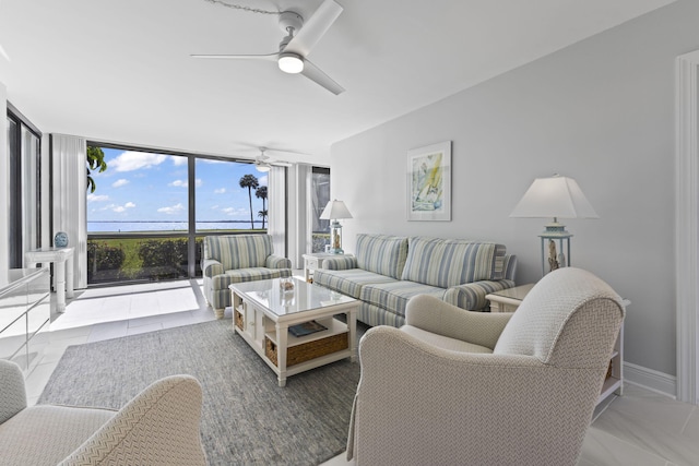 living room with expansive windows and ceiling fan