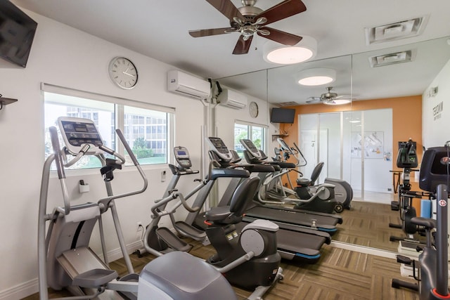 workout area featuring parquet flooring, a wealth of natural light, and an AC wall unit