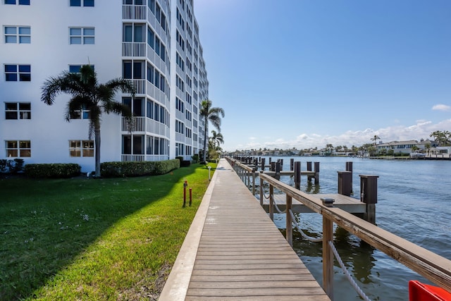 view of dock featuring a yard and a water view