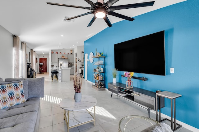 tiled living room with ceiling fan