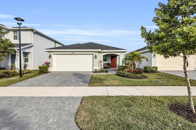 view of front of property with a garage and a front yard