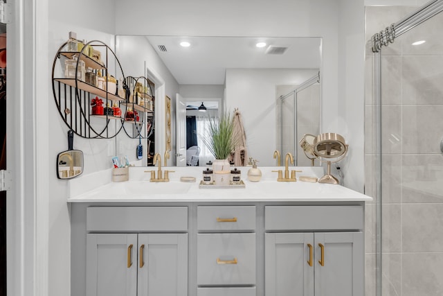 bathroom with vanity, ceiling fan, and walk in shower